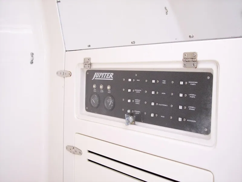 Slide: The Image of Control panel of a 2003 Jupiter 31 Center Console boat, featuring gauges and switches. - 15