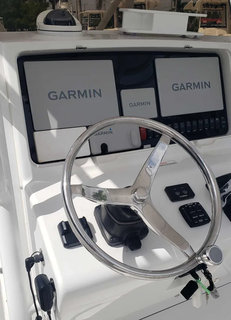 Slide: The Image of 2003 Jupiter 31 Center Console boat dashboard with Garmin navigation displays. - 4
