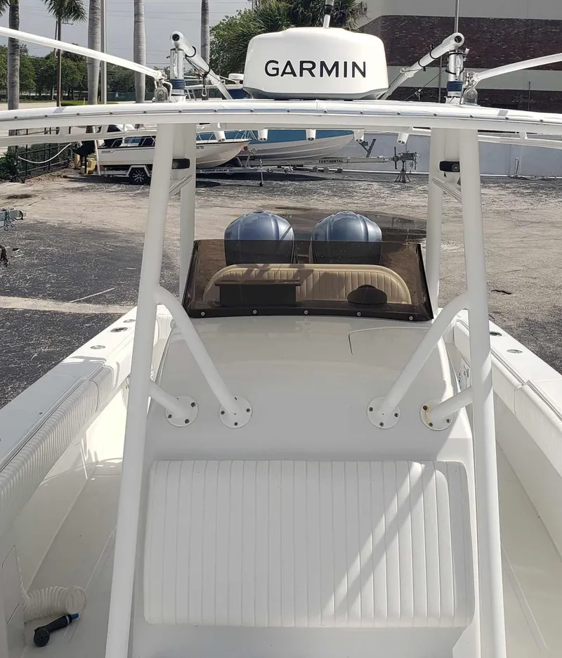Slide: The Image of 2003 Jupiter 31 Center Console boat with Garmin equipment, docked outdoors. - 5