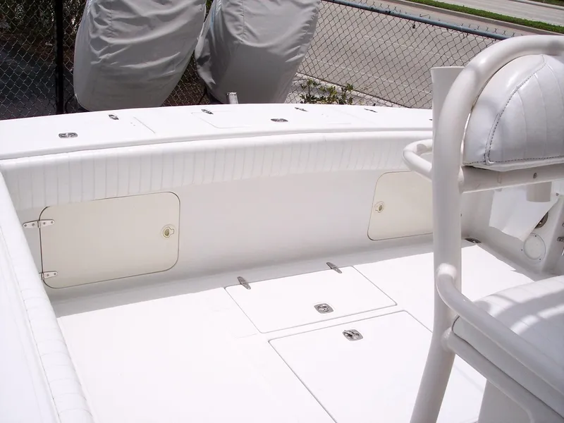 Slide: The Image of 2003 Jupiter 31 Center Console boat interior, featuring white seating and storage compartments. - 9