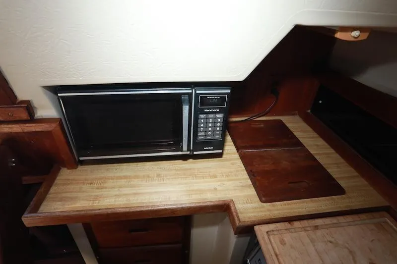 Slide: The Image of Microwave in 1985 Catalina 30 yacht kitchen with wooden countertop. - 10