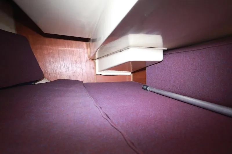 Slide: The Image of Interior cabin view of a 1985 Catalina 30 sailboat with purple cushions. - 12