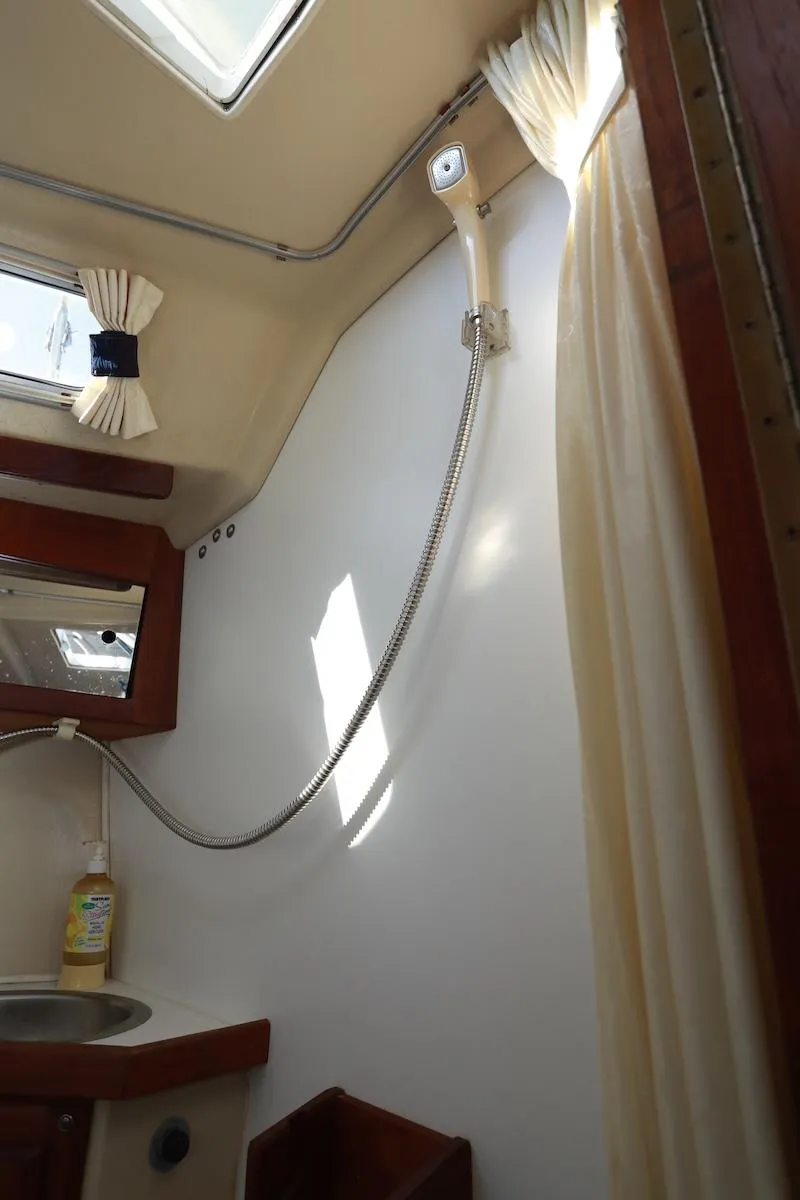 Slide: The Image of Interior of a 1985 Catalina 30 sailboat bathroom with sink and shower. - 14