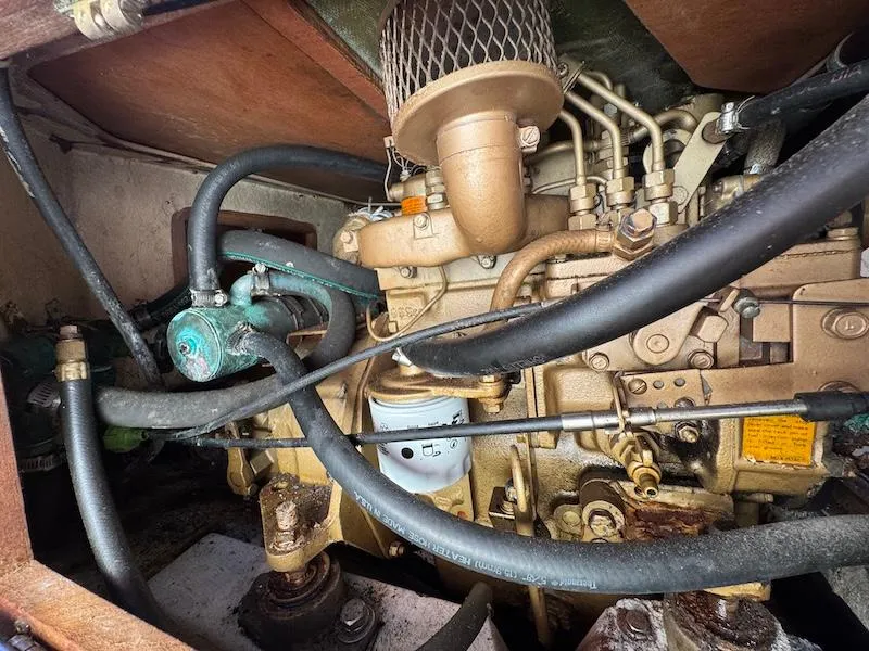 Slide: The Image of 1985 Catalina 30 engine compartment with visible hoses and components. - 15