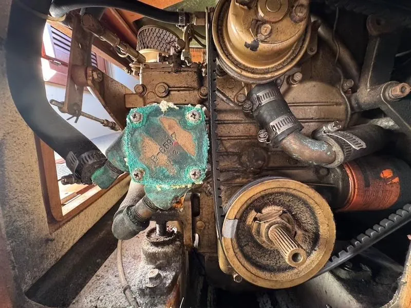 Slide: The Image of Engine components of a 1985 Catalina 30 sailboat, showing wear and corrosion. - 16