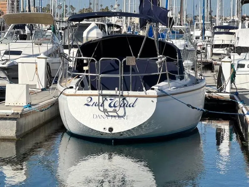 Slide: The Image of 1985 Catalina 30 sailboat docked at marina, named "2nd Wind," Dana Point. - 3