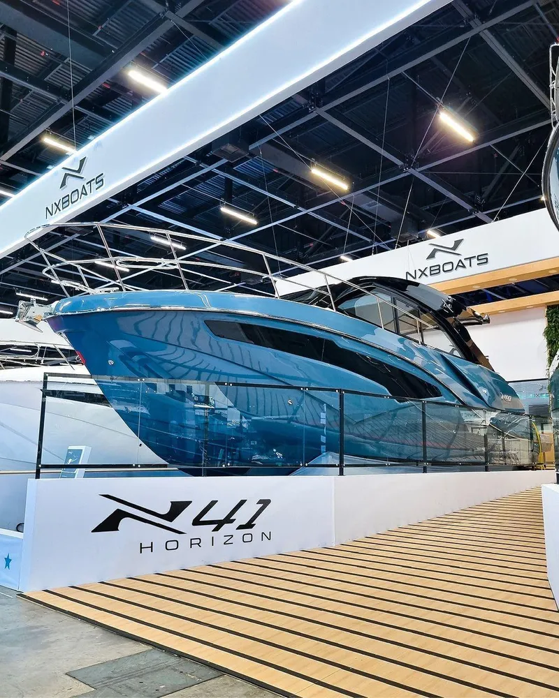 Slide: The Image of 2025 NX Boats NX41 HORIZON yacht displayed at a boat show, featuring sleek design and modern aesthetics. - 1