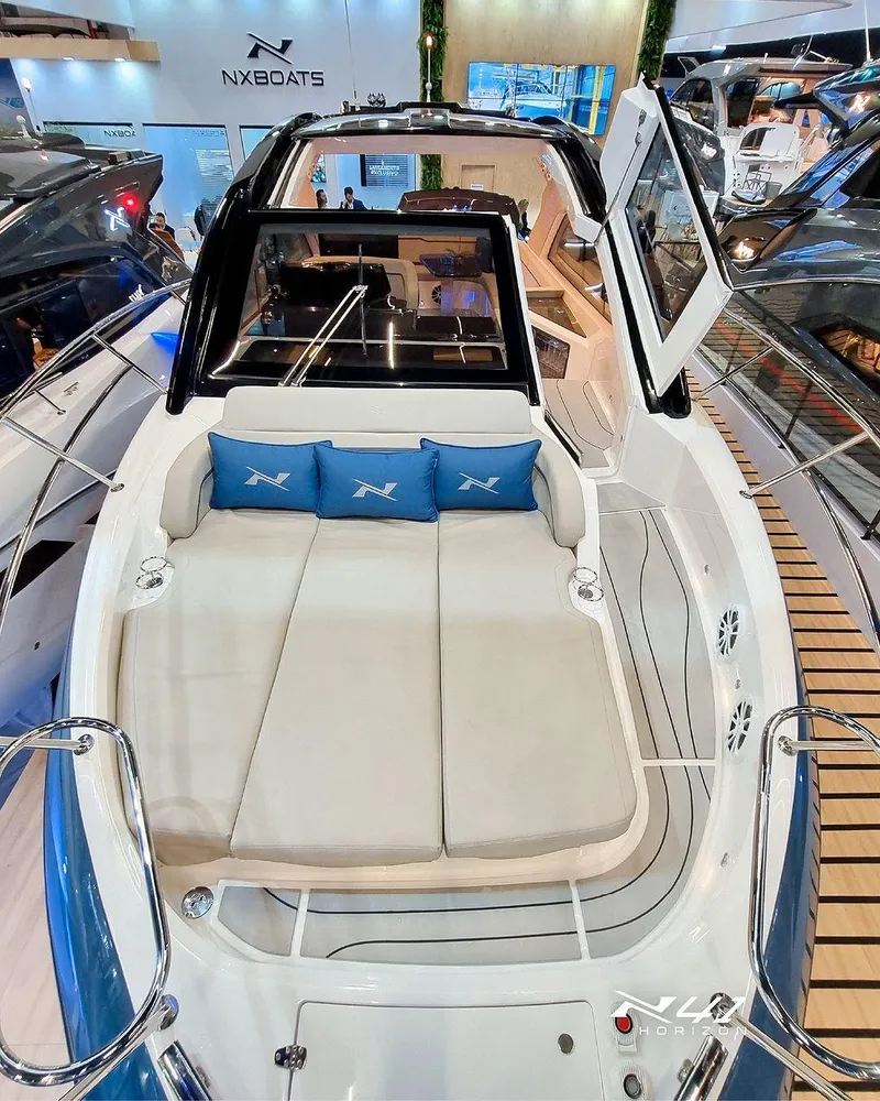 Slide: The Image of 2025 NX Boats NX41 HORIZON luxury yacht interior with cushioned seating and modern design. - 4