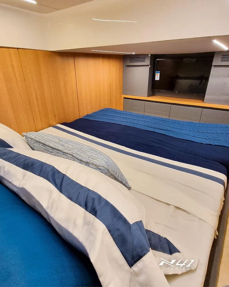 Slide: The Image of Luxurious bedroom interior of 2025 NX Boats NX41 HORIZON with modern design and cozy bedding. - 8