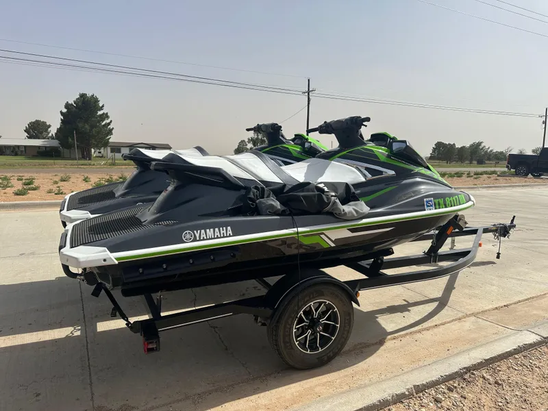 Slide: The Image of 2017 Yamaha WaveRunner VXR jet skis on a trailer, parked outdoors. - 4