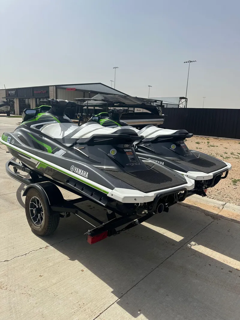 Slide: The Image of 2017 Yamaha WaveRunner VXR jet skis on a trailer, parked outdoors. - 6