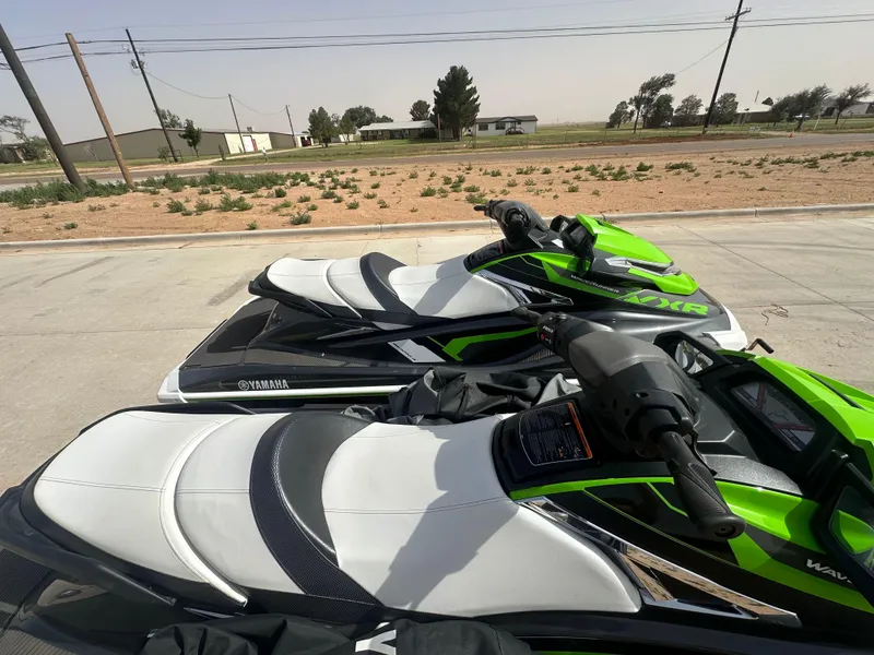 Slide: The Image of 2017 Yamaha WaveRunner VXR jet skis parked on concrete, featuring green and white design. - 9