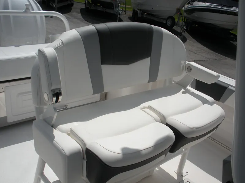 Slide: The Image of 2026 Robalo R230 Center Console boat seat, white and gray upholstery, outdoor setting. - 14