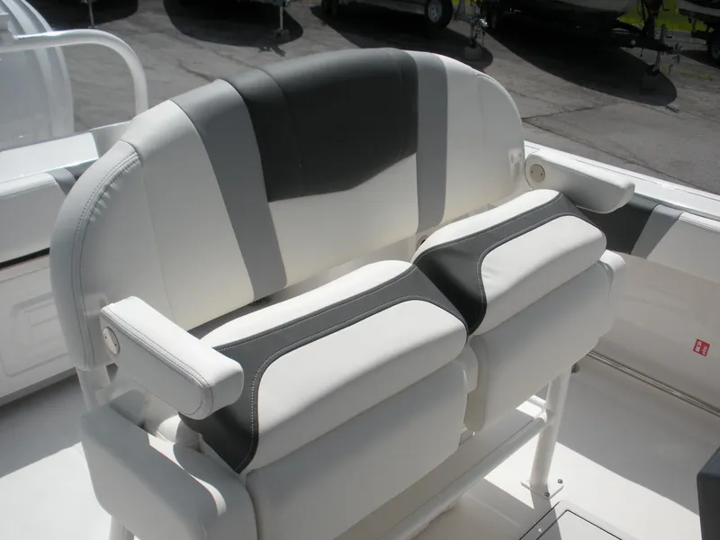 Slide: The Image of 2026 Robalo R230 Center Console boat seating, featuring stylish white and gray upholstery. - 15