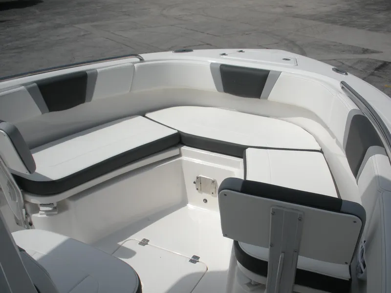 Slide: The Image of 2026 Robalo R230 Center Console boat interior with cushioned seating and sleek design. - 6