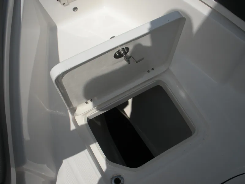 Slide: The Image of Open storage compartment on 2026 Robalo R230 Center Console boat. - 9