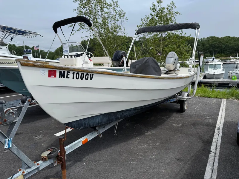 Slide: The Image of 2001 Bristol Skiff 17 boat on trailer in marina parking lot. - 1