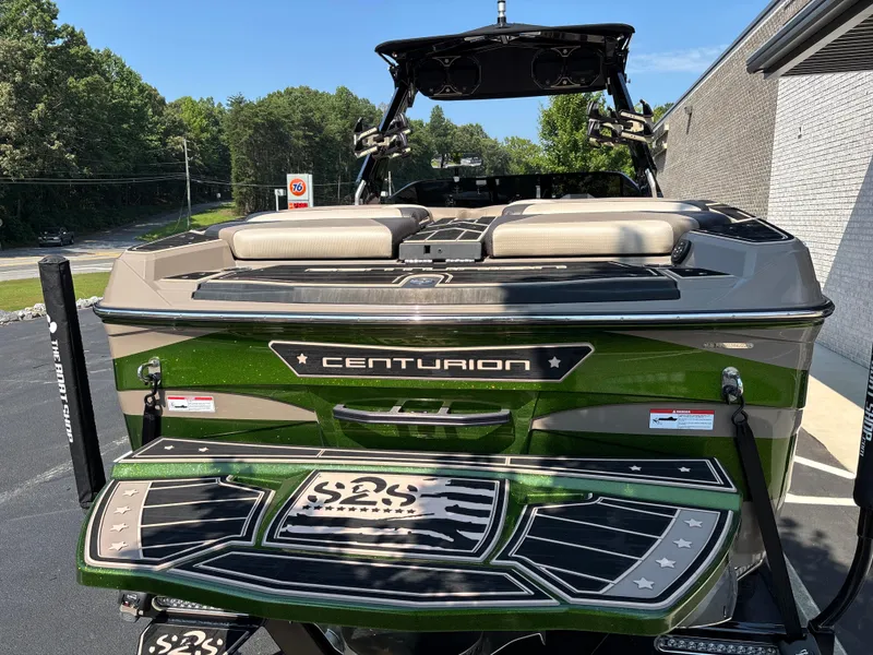 Slide: The Image of 2023 Centurion Ri265 boat, green exterior, parked outdoors, rear view. - 3