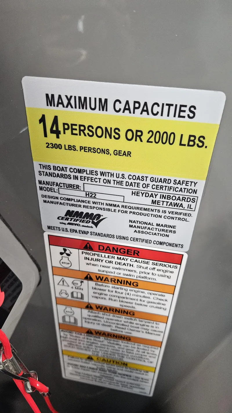 Slide: The Image of 2025 Heyday H22 boat capacity label: 14 persons or 2000 lbs, safety warnings included. - 12