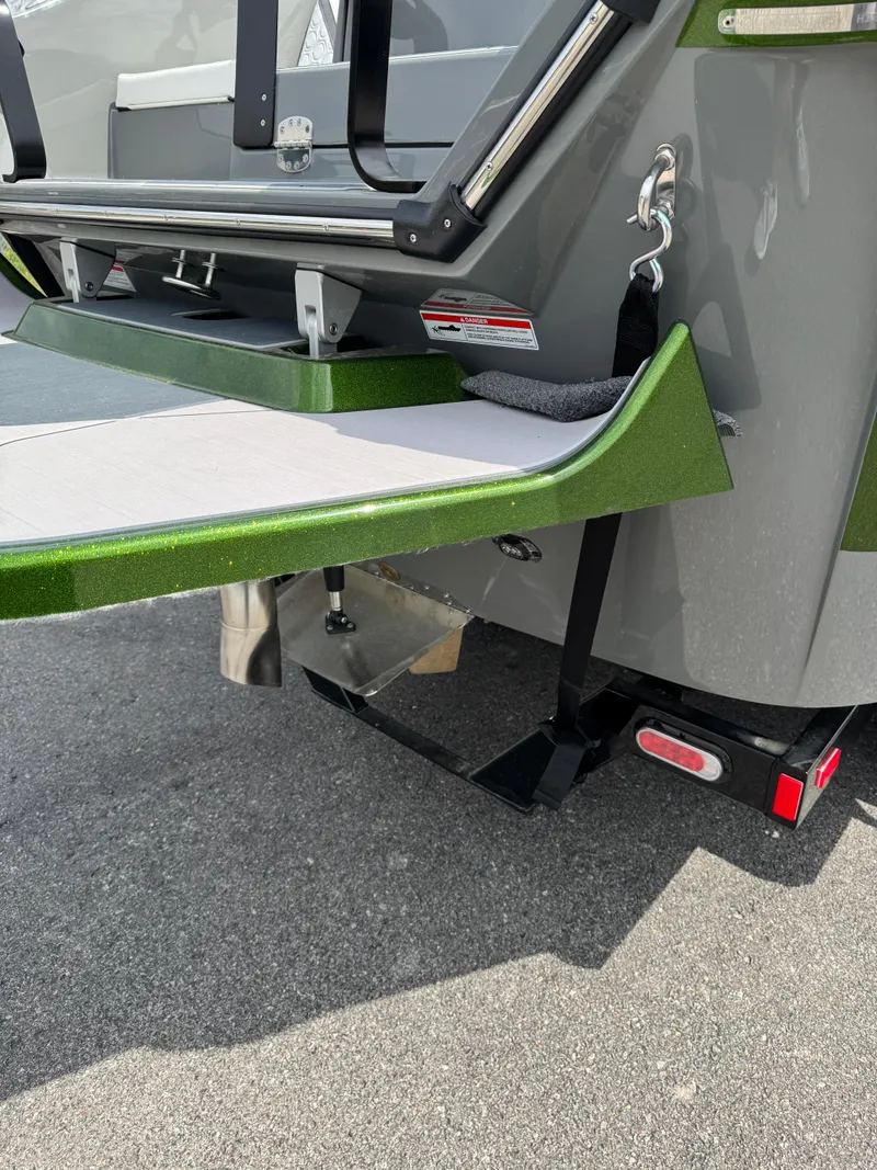 Slide: The Image of 2025 Heyday H22 boat rear view with green accents and swim platform. - 3