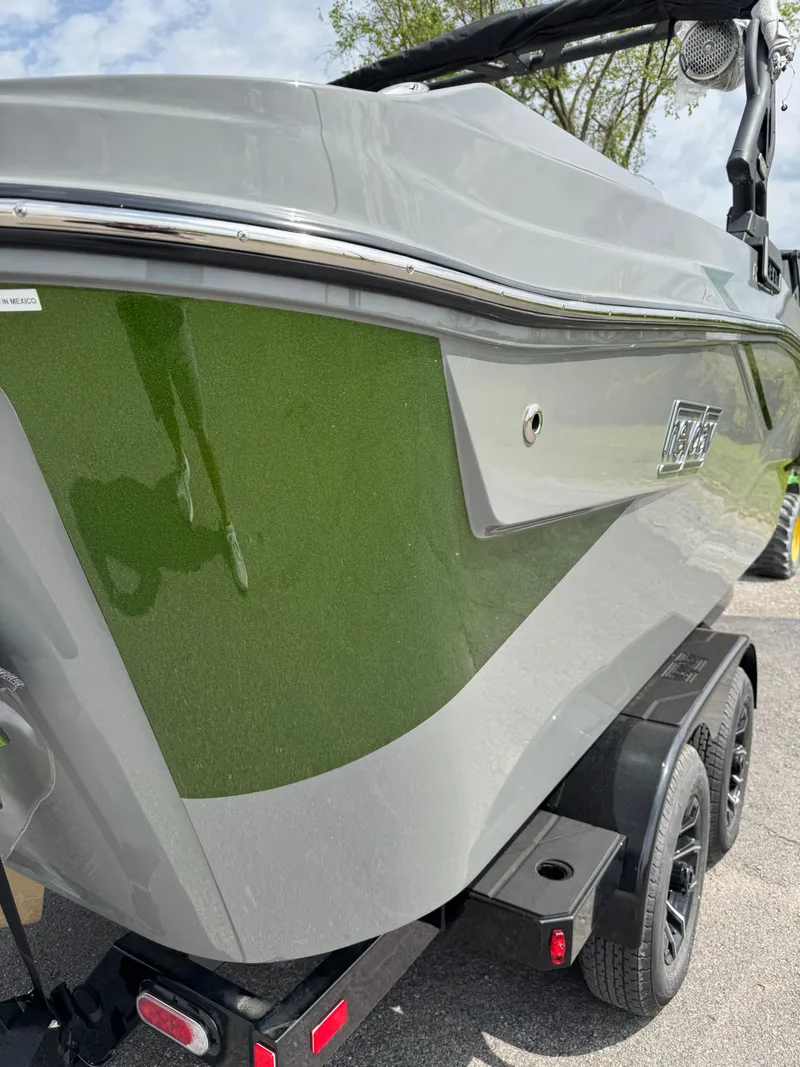 Slide: The Image of 2025 Heyday H22 boat on trailer, featuring sleek green and gray design. - 4