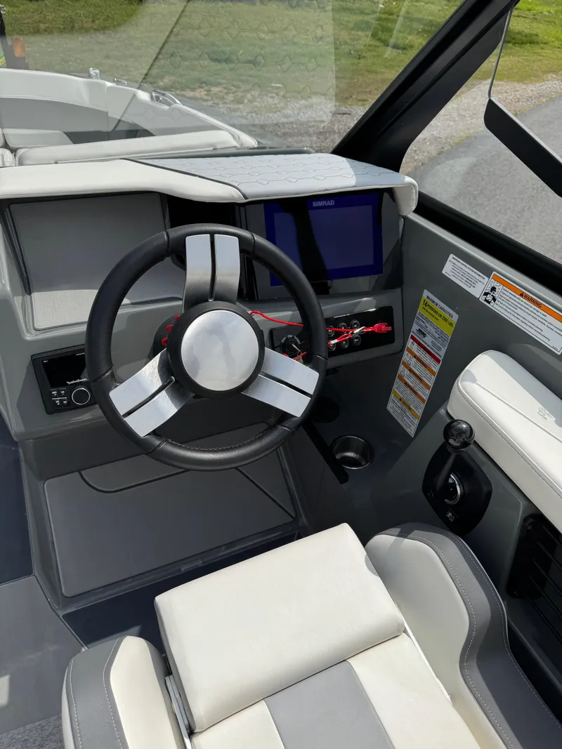 Slide: The Image of 2025 Heyday H22 boat cockpit with modern steering wheel and digital display. - 7