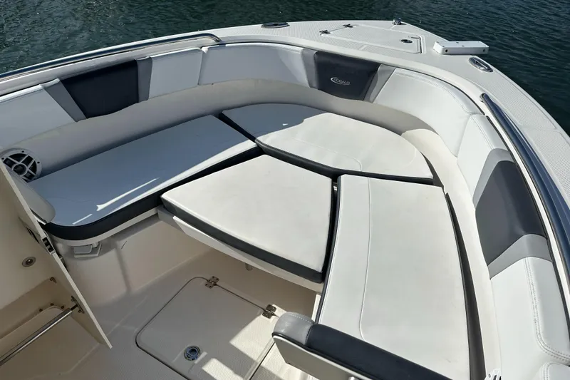 Slide: The Image of 2021 Robalo R230 Center Console boat interior with cushioned seating and storage. - 13