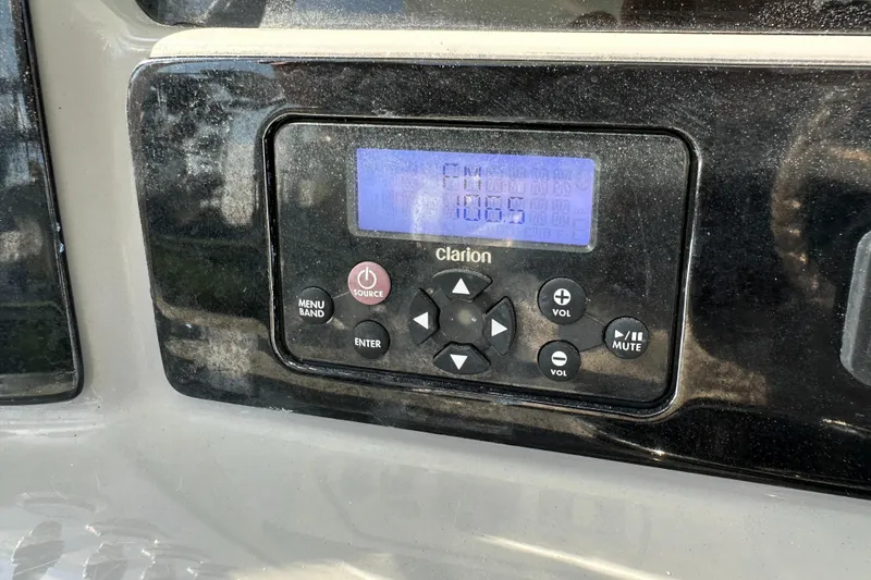 Slide: The Image of Clarion audio system in 2021 Robalo R230 Center Console boat, displaying FM 106.5. - 17
