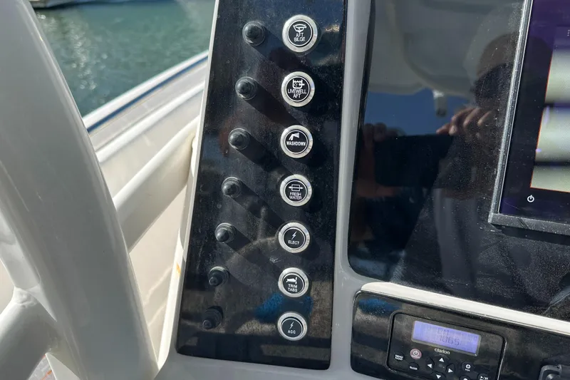 Slide: The Image of Control panel of a 2021 Robalo R230 Center Console boat with various switches. - 18