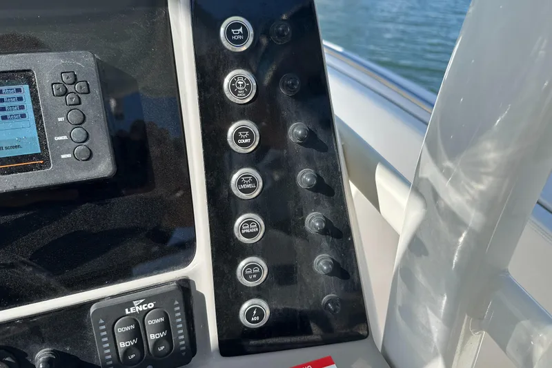 Slide: The Image of Control panel of 2021 Robalo R230 Center Console boat with various switches and display. - 19