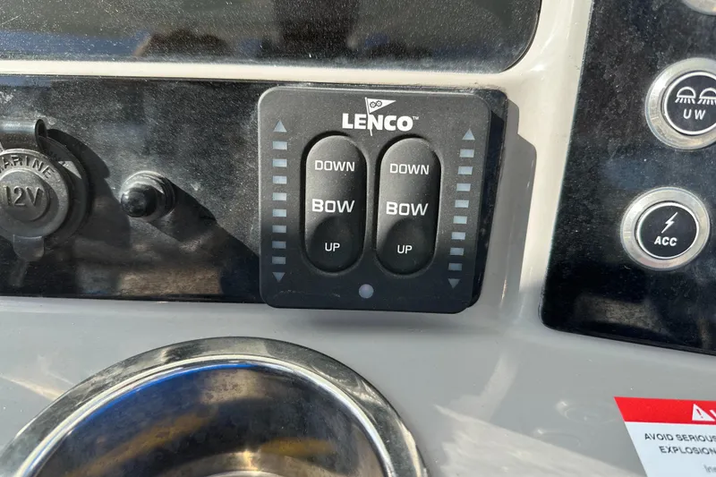 Slide: The Image of Control panel of a 2021 Robalo R230 Center Console boat with Lenco trim tab switches. - 20