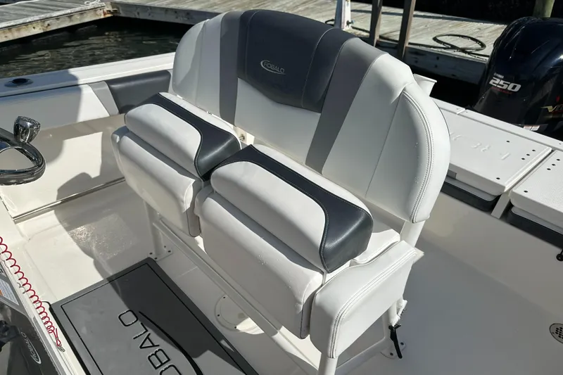 Slide: The Image of 2021 Robalo R230 Center Console boat seating with white and black upholstery. - 23