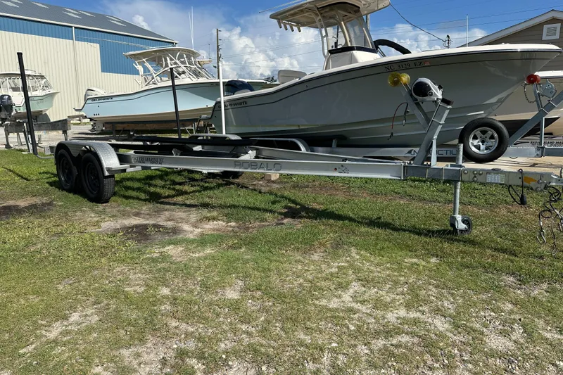 Slide: The Image of 2021 Robalo R230 Center Console boat on trailer, parked outdoors. - 29
