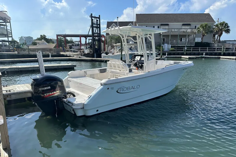 Slide: The Image of 2021 Robalo R230 Center Console boat docked in marina with Yamaha engine. - 3