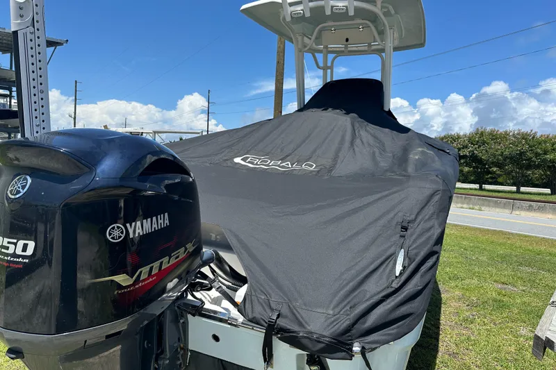 Slide: The Image of 2021 Robalo R230 Center Console boat with Yamaha VMAX engine, covered and parked outdoors. - 32