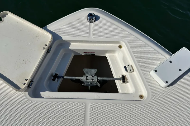 Slide: The Image of 2021 Robalo R230 Center Console anchor storage compartment open on boat deck. - 8