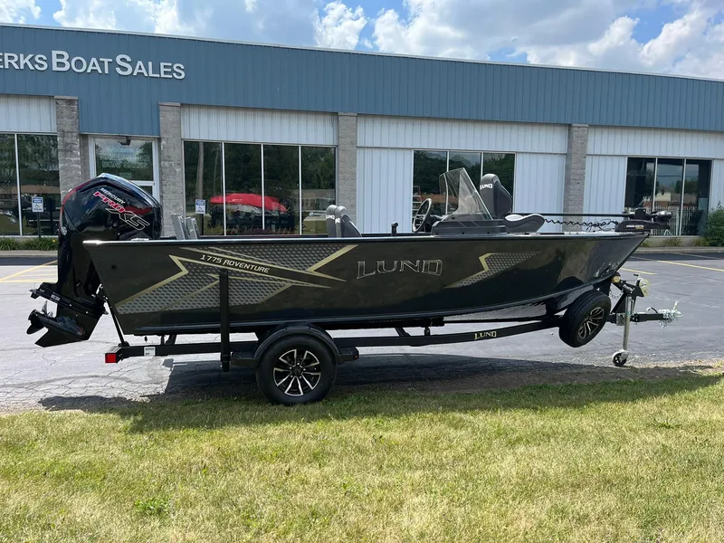 The Image of 2026 Lund 1775 Adventure SS boat on trailer outside dealership. - 0