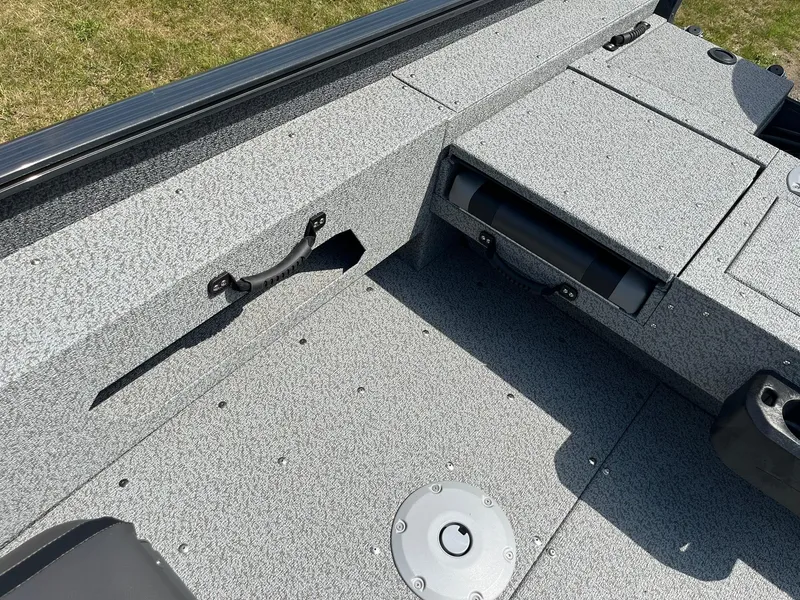 Slide: The Image of 2026 Lund 1775 Adventure SS boat interior with textured flooring and storage compartments. - 21