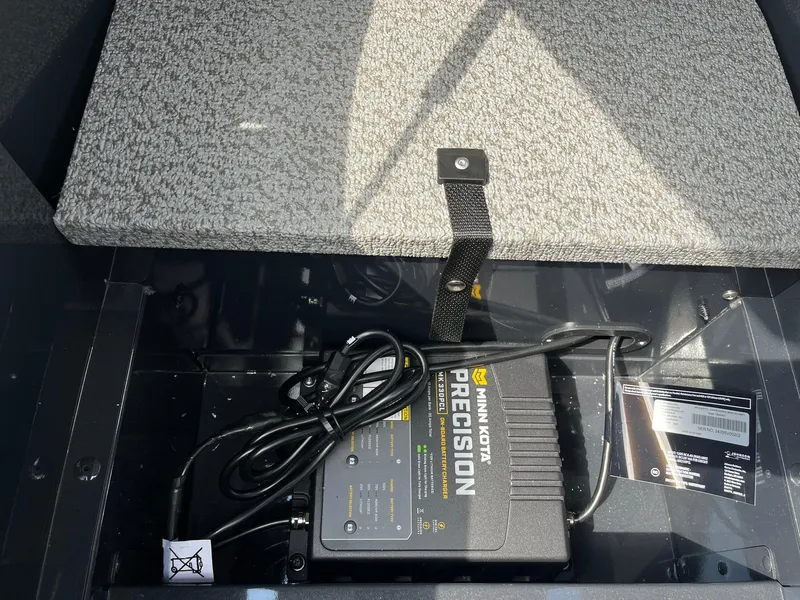 Slide: The Image of 2026 Lund 1775 Adventure SS boat battery compartment with Minn Kota Precision charger. - 23