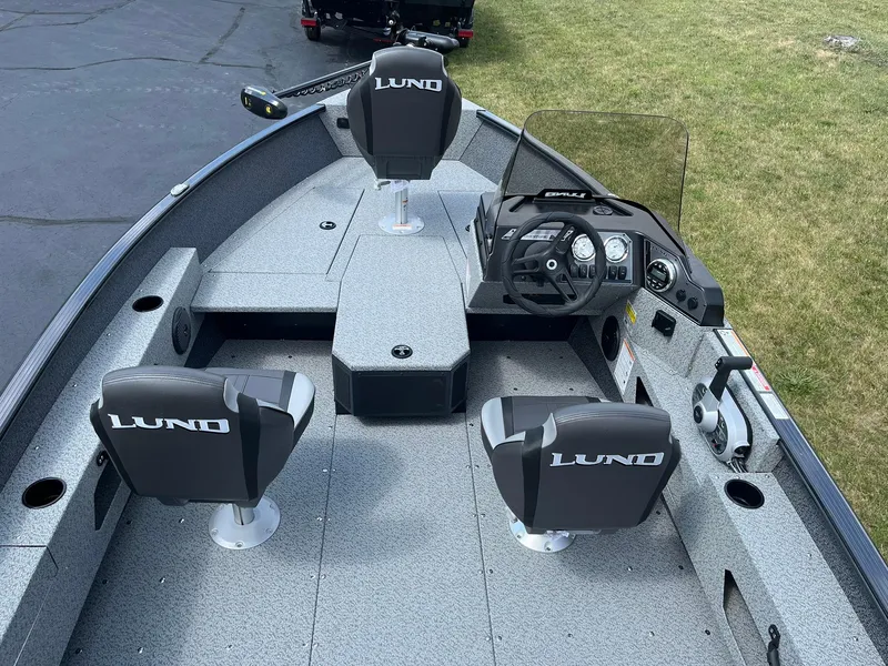 Slide: The Image of 2026 Lund 1775 Adventure SS boat interior with seating and steering console. - 5