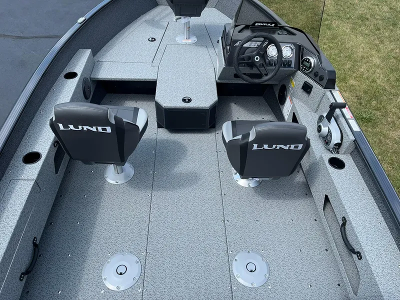 Slide: The Image of 2026 Lund 1775 Adventure SS boat interior with dual seats and modern dashboard. - 6