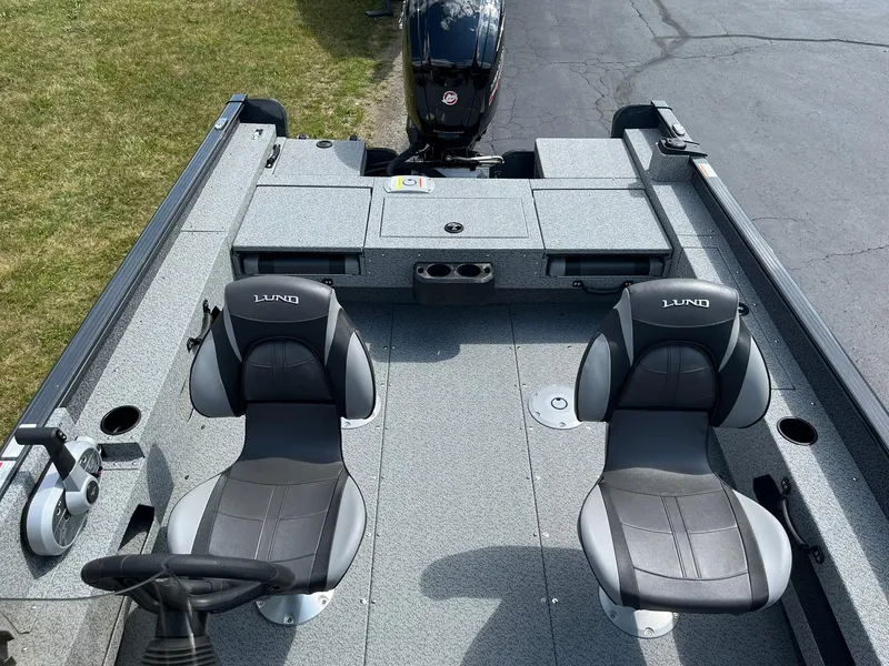 Slide: The Image of 2026 Lund 1775 Adventure SS boat interior with two seats and steering wheel. - 8