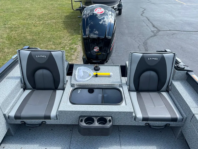 Slide: The Image of 2026 Lund 1775 Adventure SS boat interior with two seats and motor. - 9
