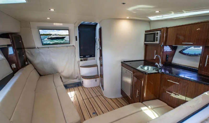 Slide: The Image of Interior of 2015 Regal 35 Sport Coupe yacht with modern kitchen and seating area. - 11