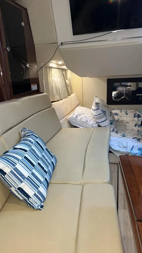 Slide: The Image of Interior of 2015 Regal 35 Sport Coupe with beige seating and striped pillows. - 14