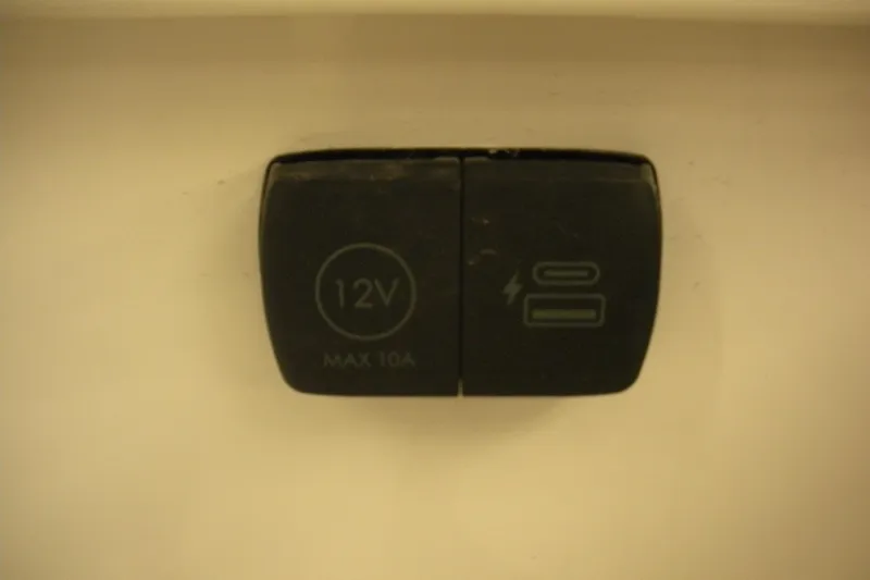 Slide: The Image of 12V power outlet on 2026 Robalo R257 Dual Console boat, max 10A. - 11