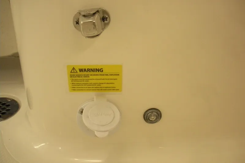 Slide: The Image of 2026 Robalo R257 Dual Console warning label and electrical outlet detail. - 15