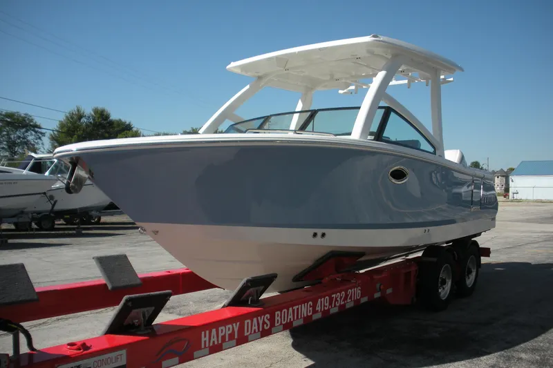 Slide: The Image of 2026 Robalo R257 Dual Console boat on trailer, displayed outdoors. - 2