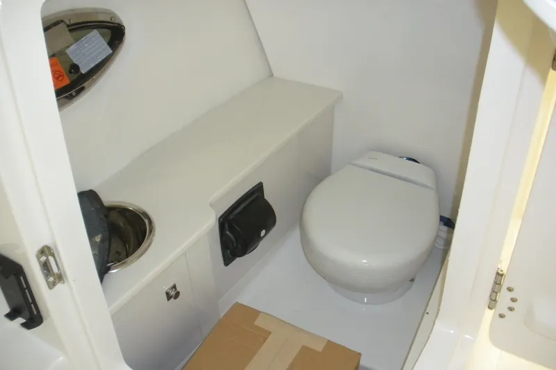 Slide: The Image of 2026 Robalo R257 Dual Console boat interior bathroom with toilet and sink. - 5
