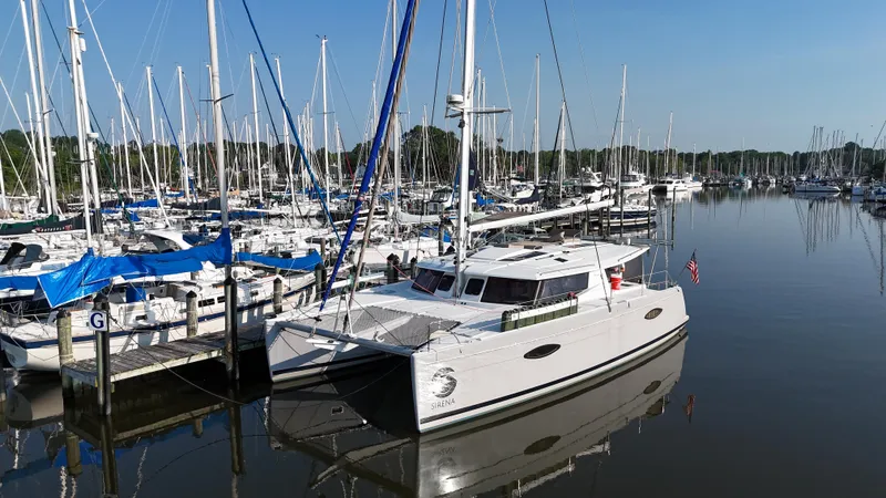 Slide: The Image of 2015 Fountaine Pajot Helia 44 catamaran docked in a marina with sailboats. - 1